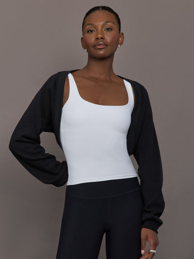 Model wearing fleece black long sleeve shrug.