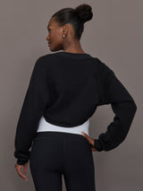 Model wearing fleece black long sleeve shrug.