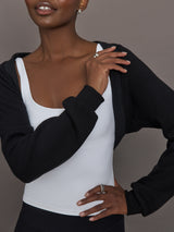 Model wearing fleece black long sleeve shrug.
