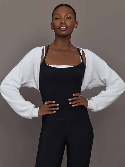 Model wearing fleece white long sleeve shrug.