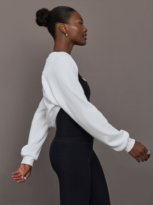 Model wearing fleece white long sleeve shrug.