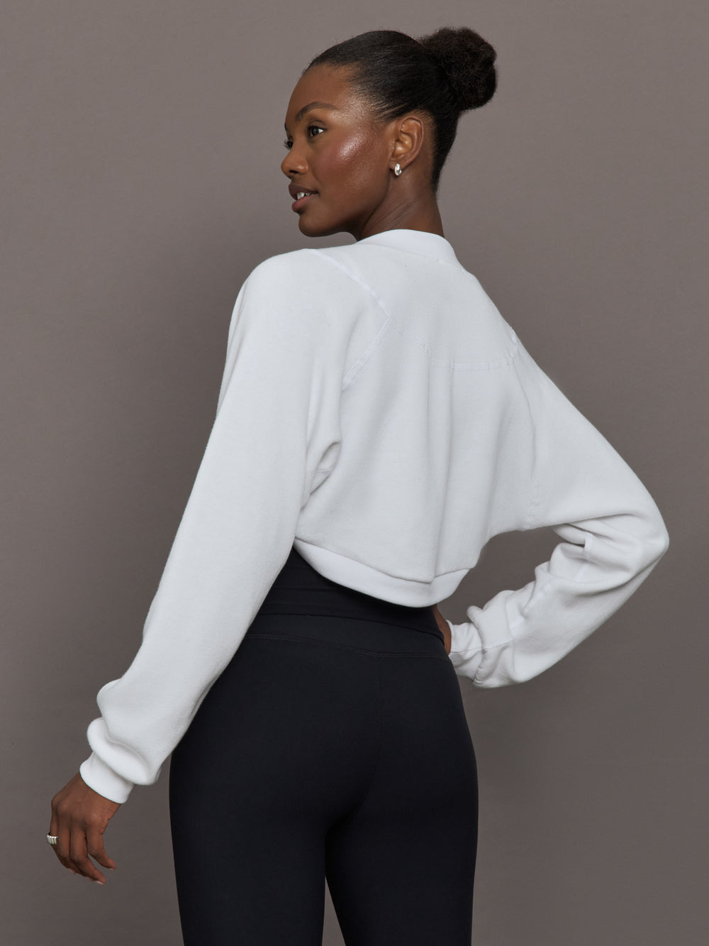 Model wearing fleece white long sleeve shrug.