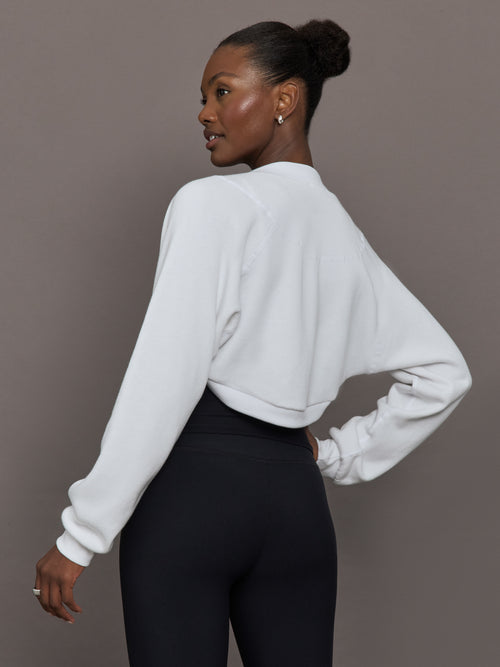 Model wearing fleece white long sleeve shrug.