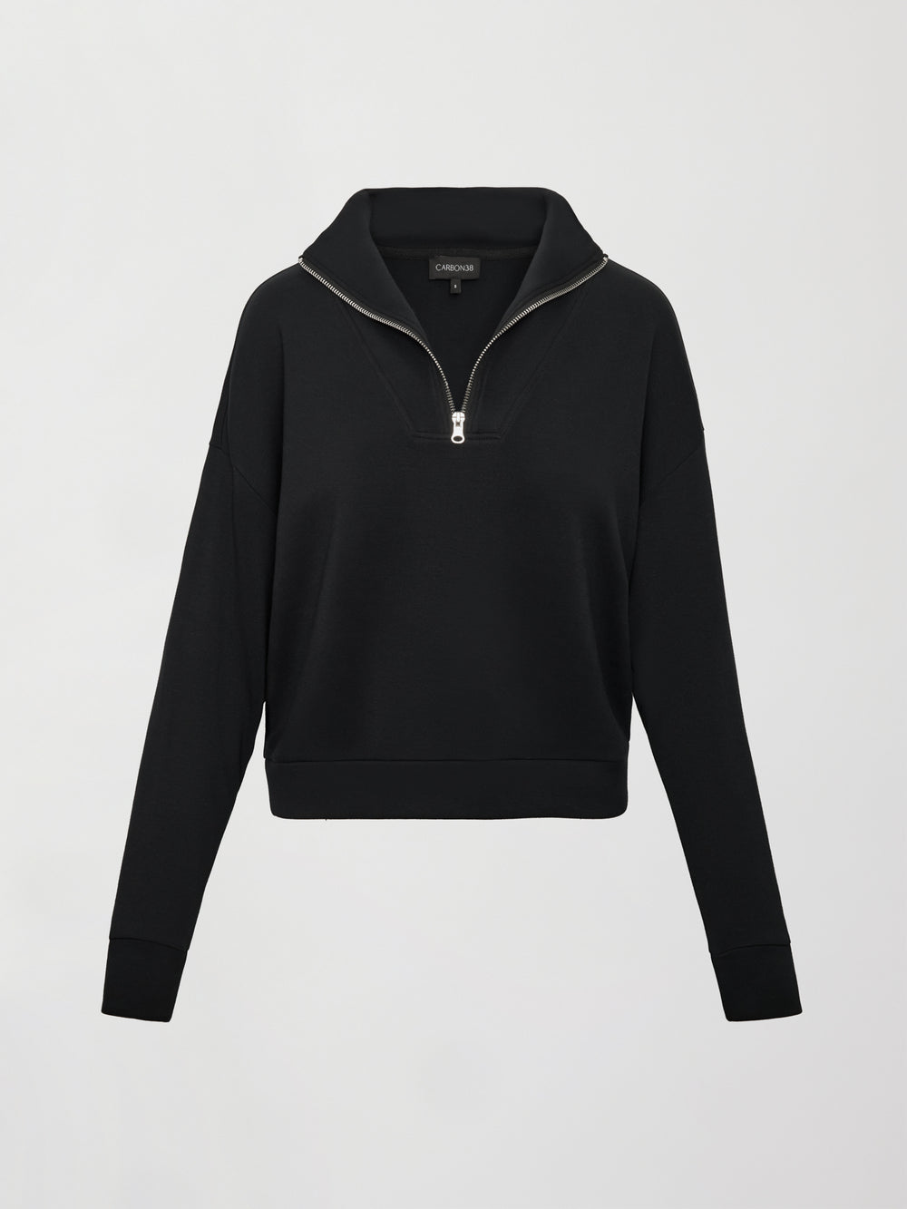 Flat lay of Interlock half zip pullover in black, front view.