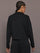 Model is wearing Interlock half zip pullover in black, back view.