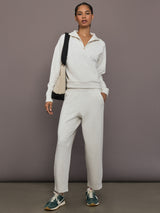 Model is wearing Interlock half zip pullover in Moonbeam Heather, full body front view.