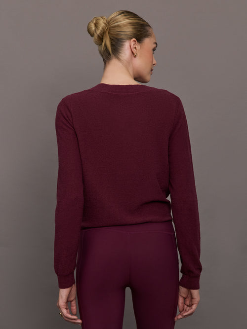 Model wearing a Fig colored long-sleeve top with knot detail