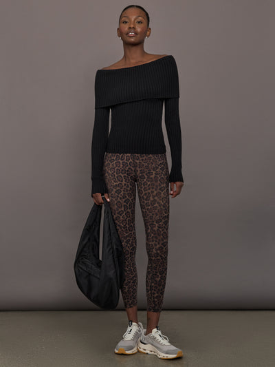 Model wearing a black off-shoulder sweater