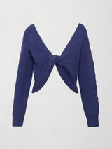 Model wearing blue sweater with a twist in the back.