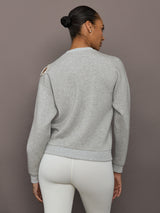 Back view of grey bow embellished sweatshirt in heather grey with shoulder cutout bow detail.