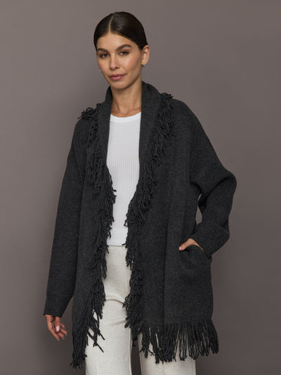 Model wearing Tassel Shawl Collar Sweater in charcoal with fringe trim, front view.