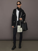 Full look with Sweater with Scarf in black and cream styled with leggings, boots, sunglasses, and tote bag, front view.