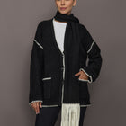 Model wearing Sweater with Scarf in black with cream whipstitch trim and fringe scarf, front view.