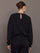 Back view of black jewel embellished sweatshirt with keyhole closure at neck.