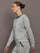 Side profile of grey jewel embellished sweatshirt with long sleeves and relaxed fit.