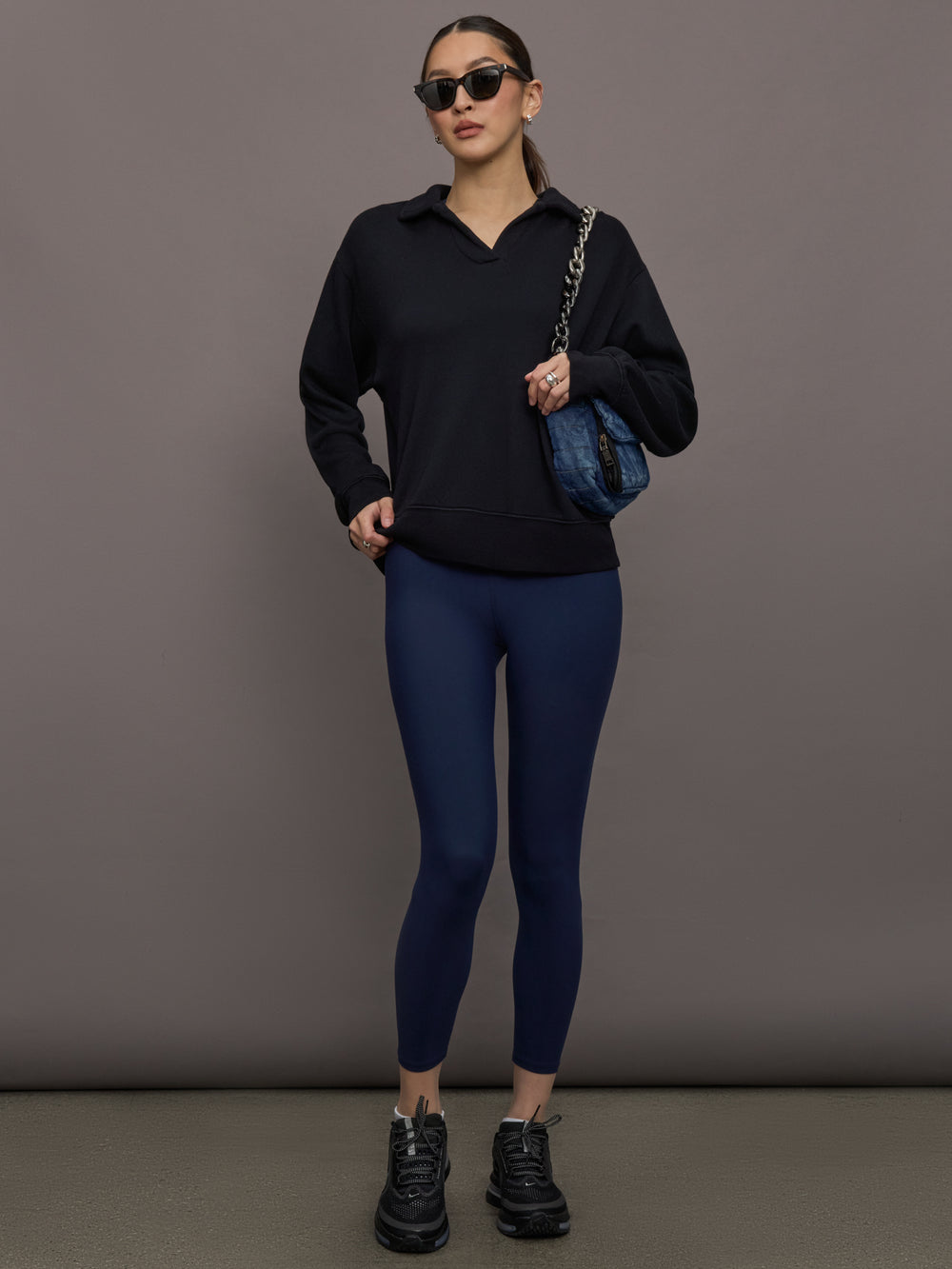 Model is wearing French Terry Johnny Collar Sweatshirt in Black, full body view styled with leggings.