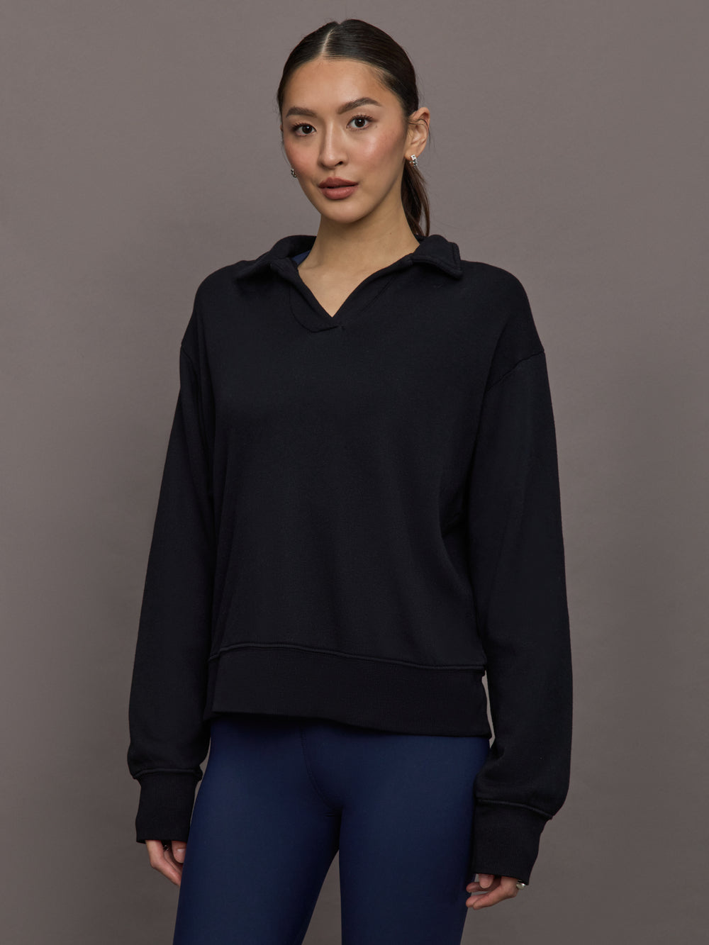 Model is wearing French Terry Johnny Collar Sweatshirt in Black, front view.