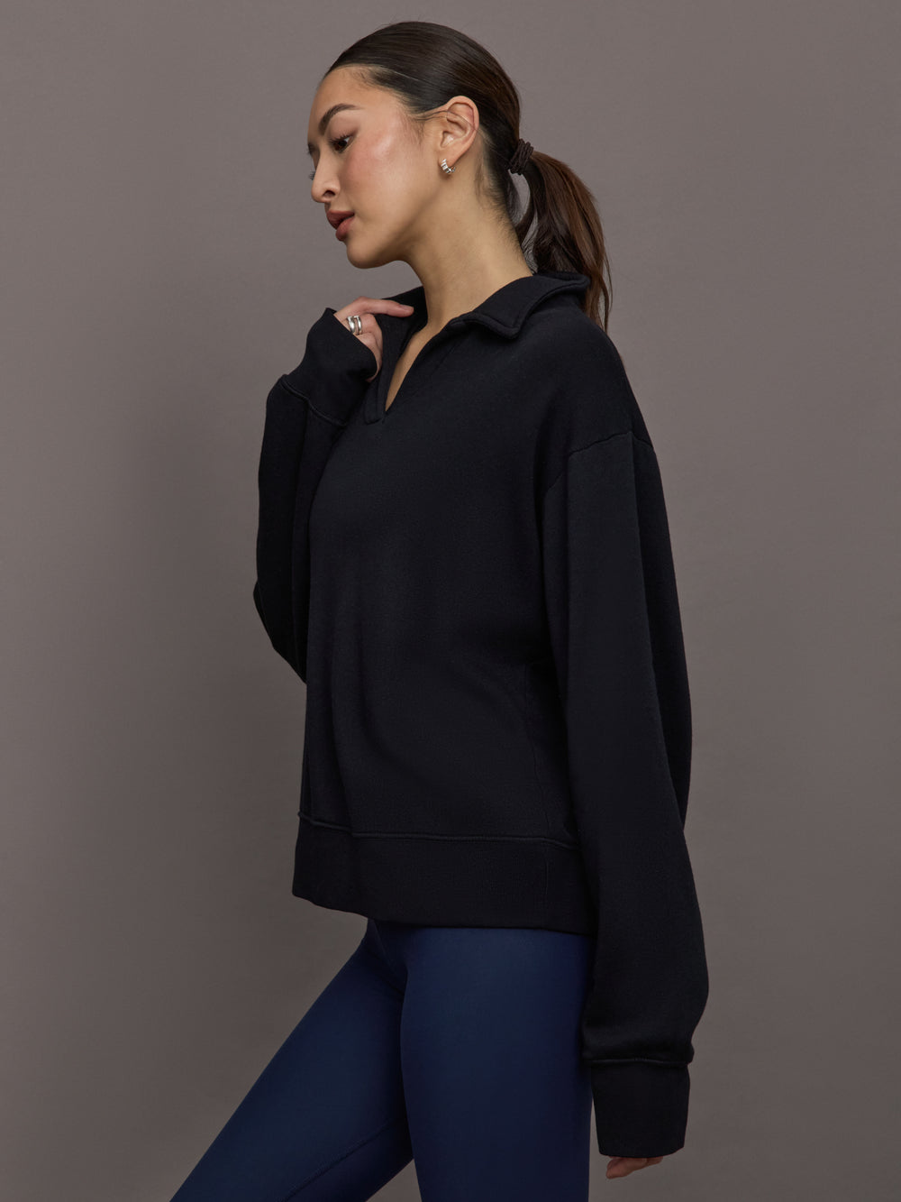 Model is wearing French Terry Johnny Collar Sweatshirt in Black, side profile view.