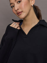 Model is wearing French Terry Johnny Collar Sweatshirt in Black, close-up of collar detail.