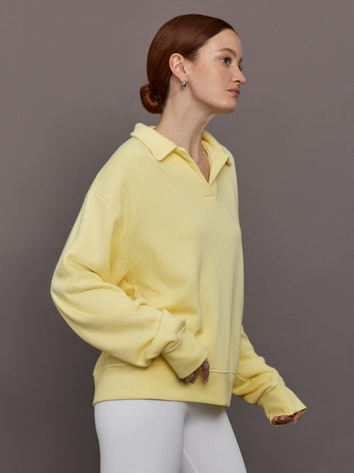 Model is wearing French Terry Johnny Collar Sweatshirt in Banana, side profile view.
