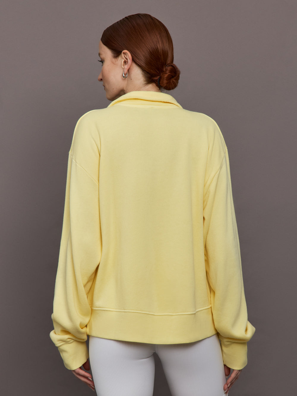 Model is wearing French Terry Johnny Collar Sweatshirt in Banana, back view.