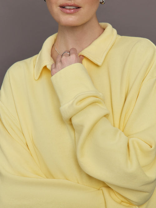 Model is wearing French Terry Johnny Collar Sweatshirt in Banana, close-up collar detail.