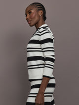 Model is wearing Johnny Collar Striped Sweater in black and cream, side view.