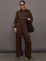 Model is wearing Scuba Mid Rise Pull On Pant in Carafe, full body styled with tote and sunglasses.