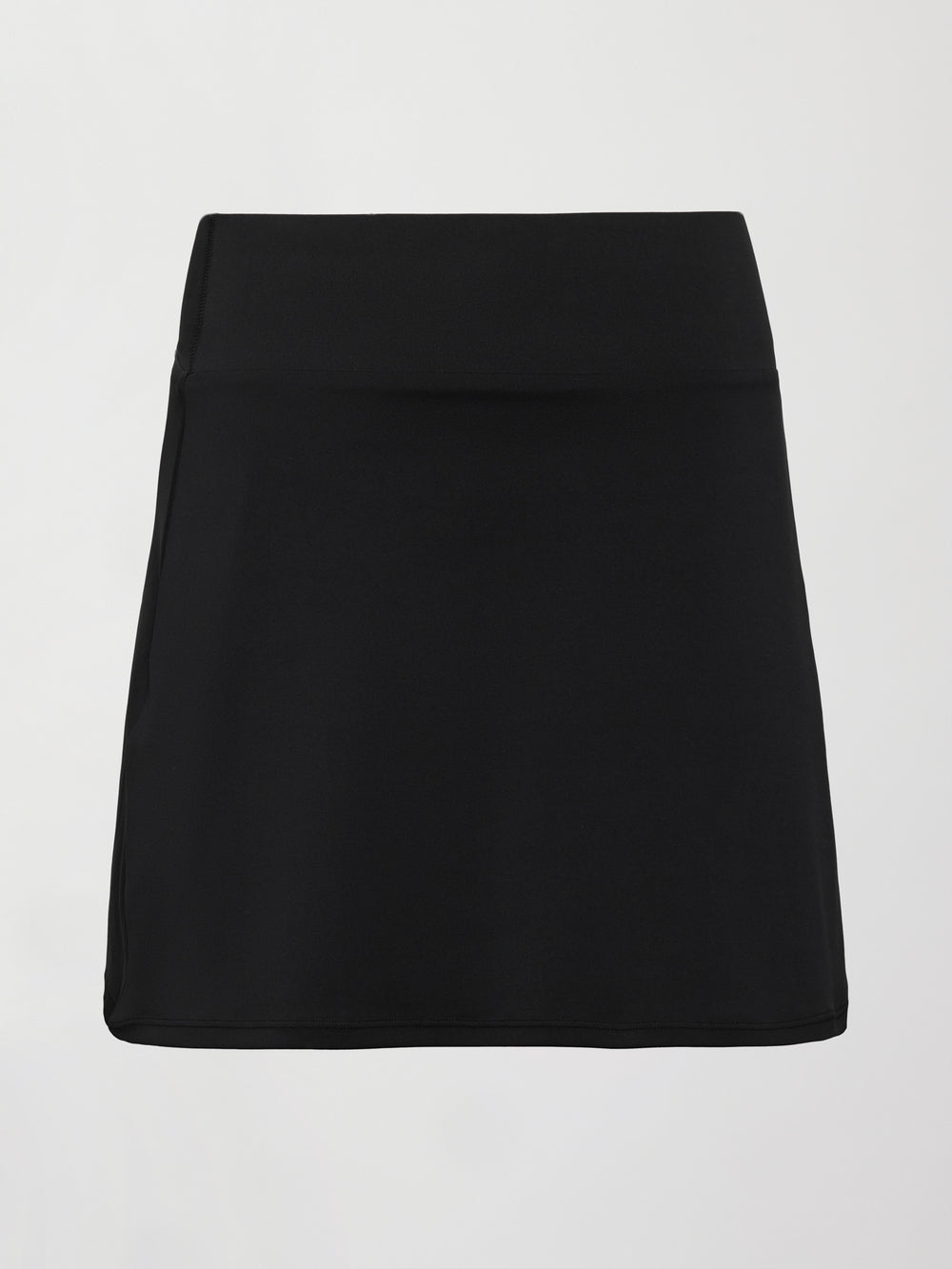 Model wears black tennis skirt with a smooth, fitted waistband and subtle flare.
