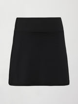 Model wears black tennis skirt with a smooth, fitted waistband and subtle flare.
