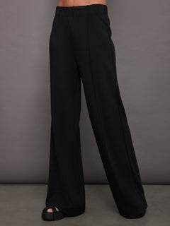 Women’s black pintuck knit pants, front view.