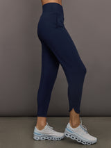 Model wears navy high-rise joggers with a slim, relaxed fit and a slightly cropped tulip-shaped hem and a wide waistband.
