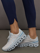 Model wears navy high-rise joggers with a slim, relaxed fit and a slightly cropped tulip-shaped hem and a wide waistband.
