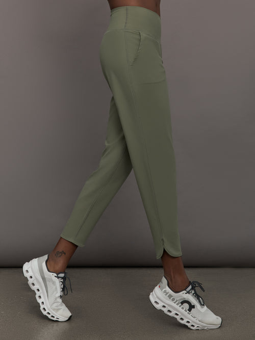 Model wears a pair of army green colored joggers with a thick waistband perfect for everyday activities. 