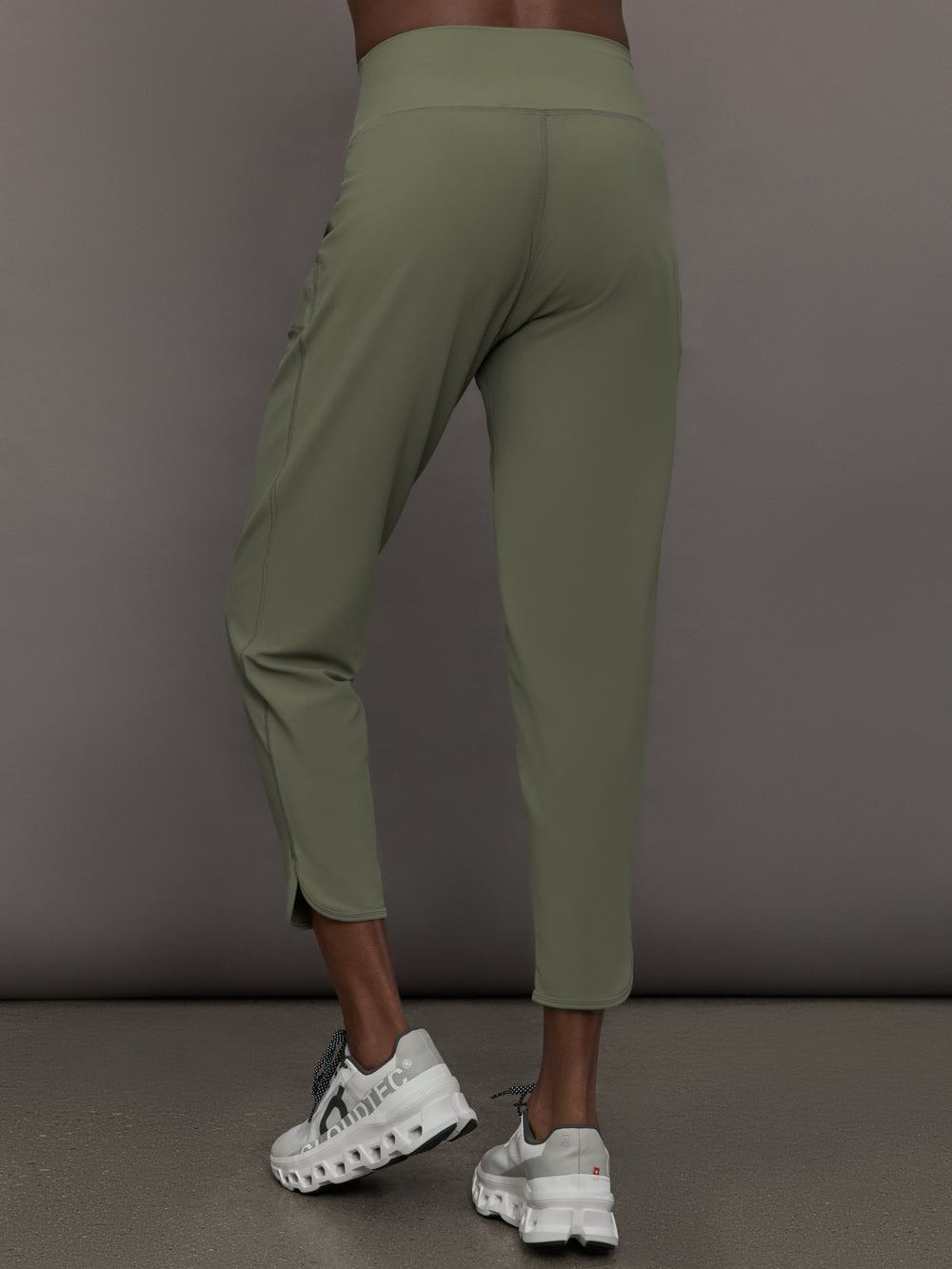 Model wears a pair of army green colored joggers with a thick waistband perfect for everyday activities. 