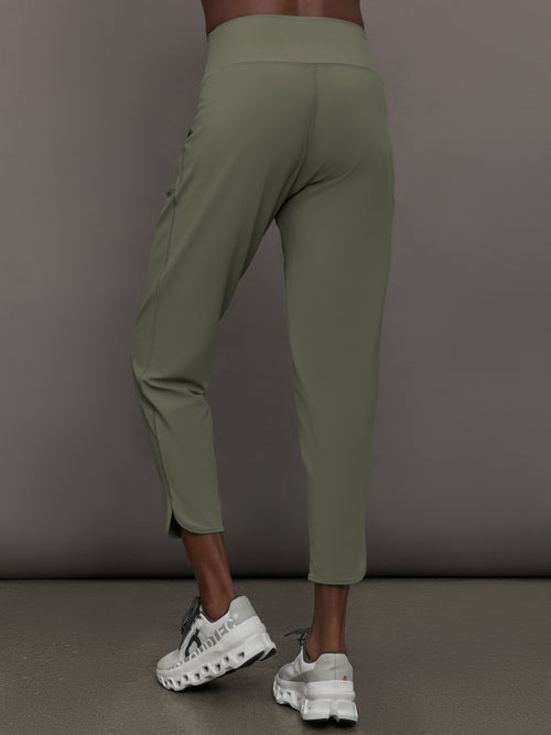 Model wears a pair of army green colored joggers with a thick waistband perfect for everyday activities. 