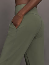 Model wears a pair of army green colored joggers with a thick waistband perfect for everyday activities. 