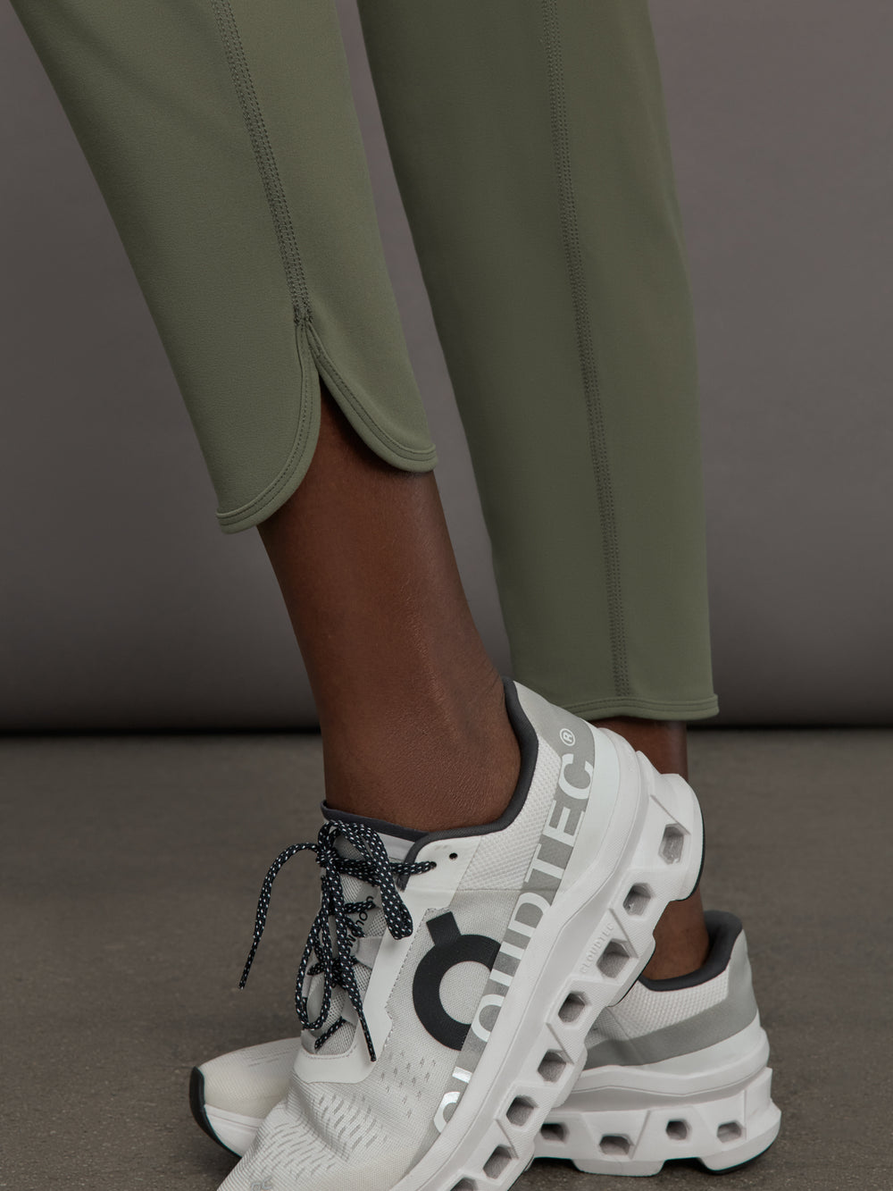 Model wears a pair of army green colored joggers with a thick waistband perfect for everyday activities. 