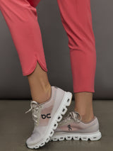 Model wears a buttery soft, high waisted, salmon pink colored pair of jogger sweatpants. 