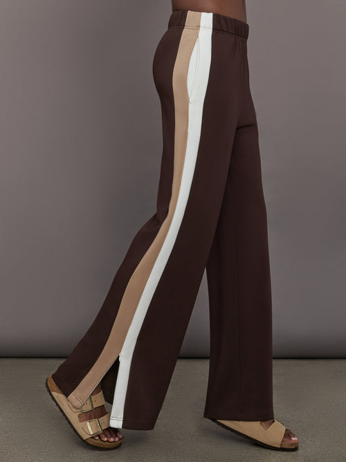 Model wearing Brown wide-leg pants with a white and beige stripe