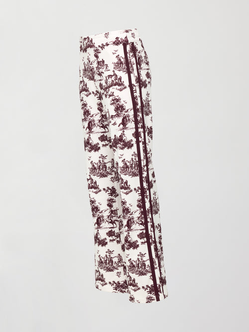White track pants with burgundy toile print. 