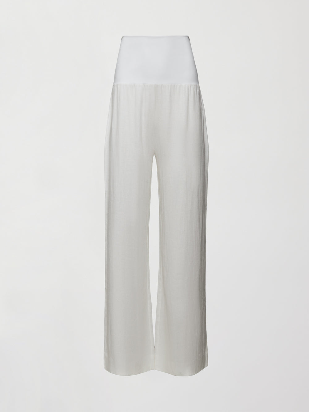 Model wears high-waisted, white wide-leg linen pants.