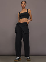 Model is wearing Interlock barrel leg pant in black, full body view.