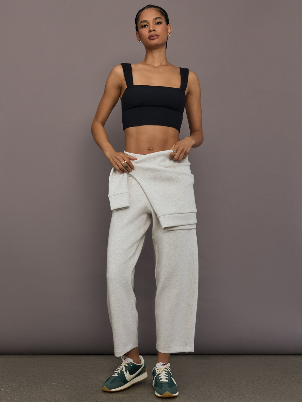 Model is wearing Interlock barrel leg pant in Moonbeam Heather, full body front view.