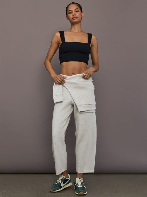 Model is wearing Interlock barrel leg pant in Moonbeam Heather, full body front view.