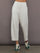 Model is wearing Interlock barrel leg pant in Moonbeam Heather, front view.