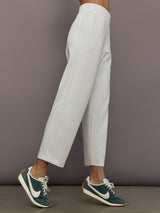 Model is wearing Interlock barrel leg pant in Moonbeam Heather, side profile view.