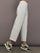 Model is wearing Interlock barrel leg pant in Moonbeam Heather, side profile view.