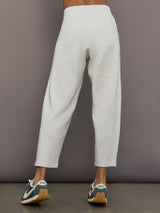 Model is wearing Interlock barrel leg pant in Moonbeam Heather, back view.