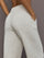 Model is wearing Interlock barrel leg pant in Moonbeam Heather, close-up pocket detail.